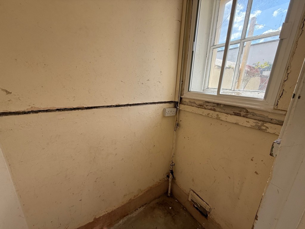 Lot: 110 - THREE-BEDROOM END-TERRACE COTTAGE FOR IMPROVEMENT - Utility cupboard with window to the rear